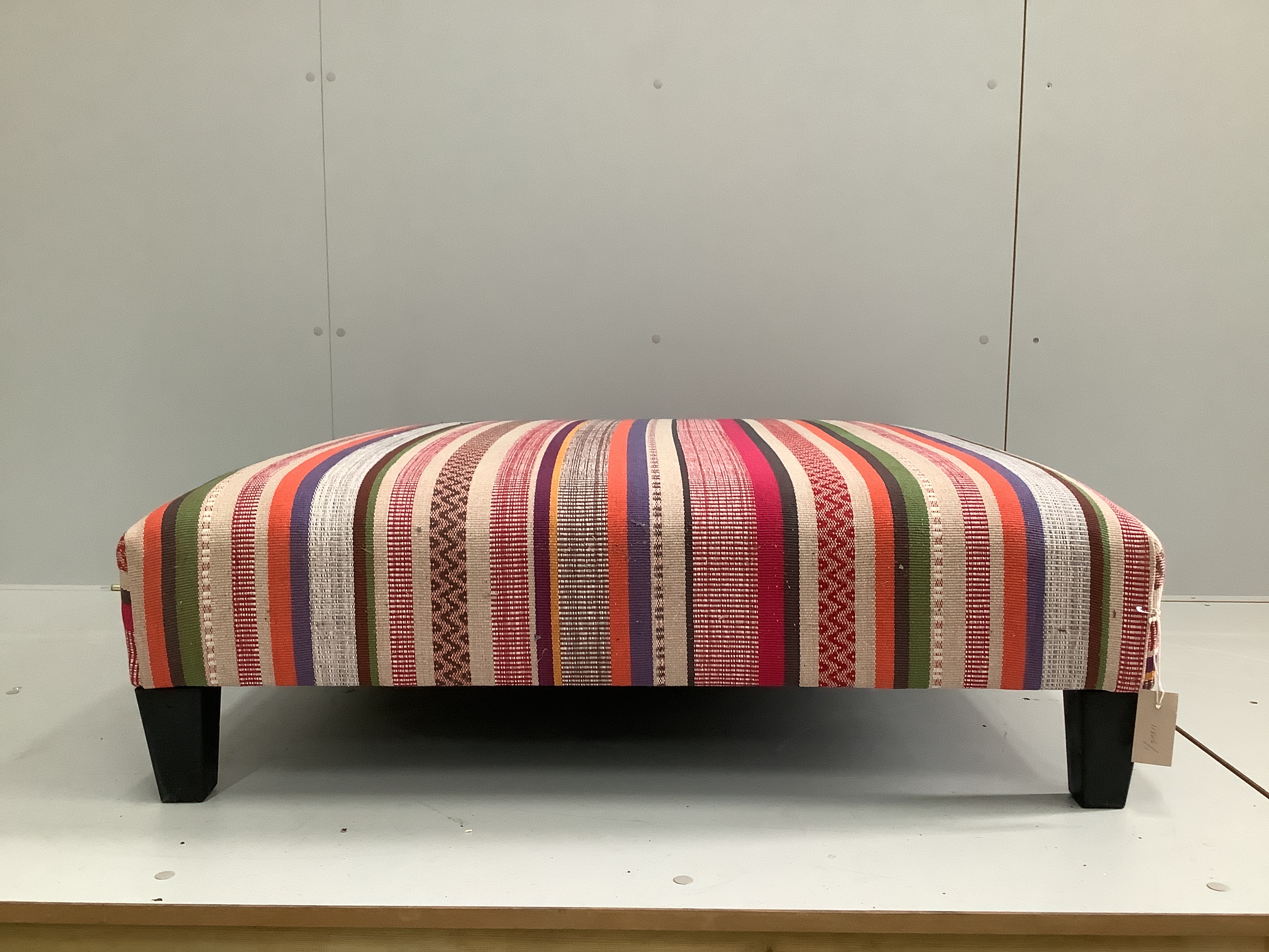 A large contemporary square footstool upholstered in Jane Churchill Cabrera Stripe, width 98cm, height 30cm